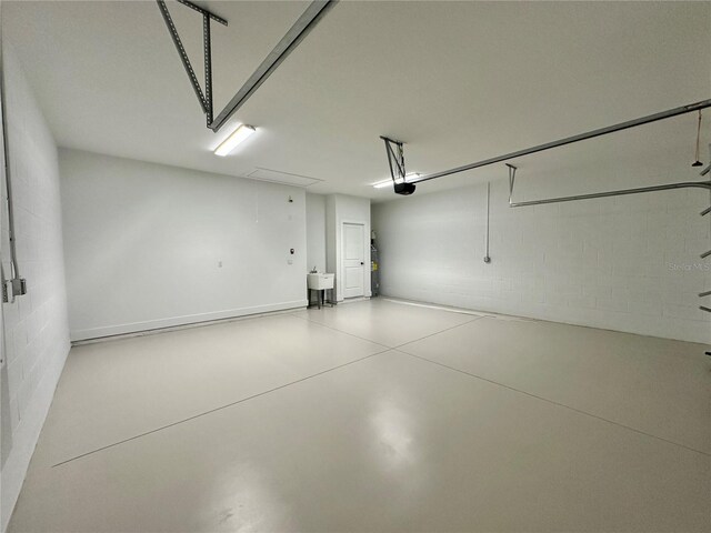 6 Lake Pl, Palm Coast, FL 32137 - garage with a garage door opener and concrete block wall