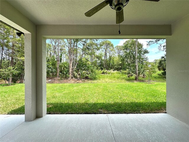 6 Lake Pl, Palm Coast, FL 32137 - view of grassy yard with a patio area, view of scattered trees, and a ceiling fan