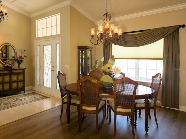 dining area featuring a notable chandelier, dark hardwood / wood-style flooring, and ornamental molding