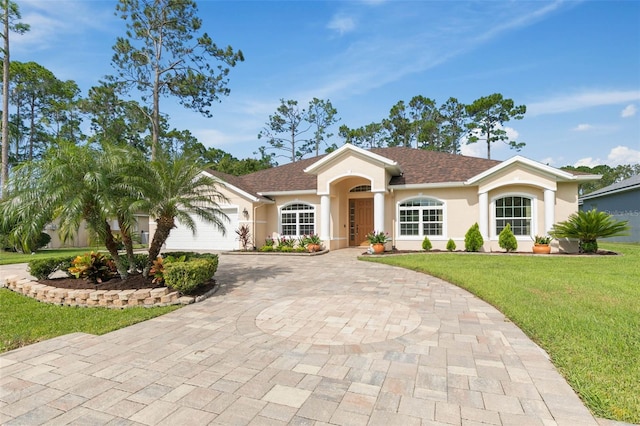 single story home with a front lawn and a garage