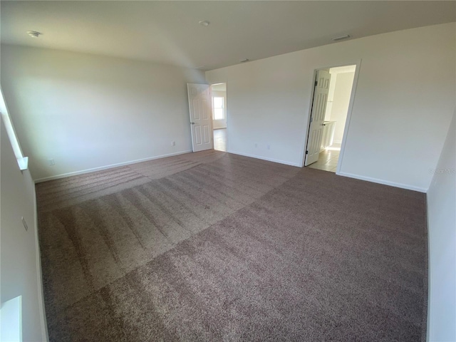 empty room featuring dark carpet