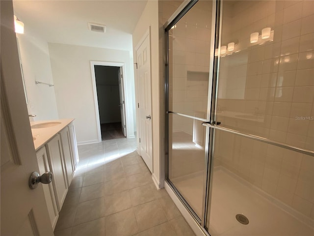 bathroom featuring vanity, tile patterned floors, and an enclosed shower