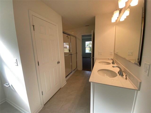 10 Windor Ter, Palm Coast, FL 32164 - full bathroom with double vanity, tile patterned flooring, and a stall shower