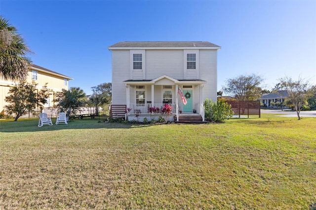 front of property featuring a porch and a front lawn