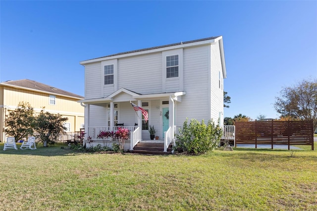 view of front property featuring covered porch and a front lawn