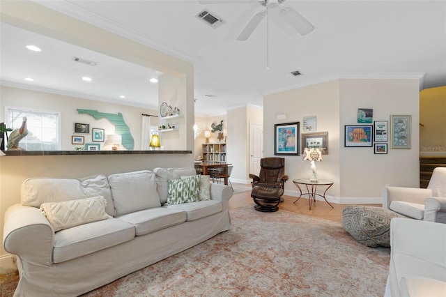 living room with ceiling fan and ornamental molding