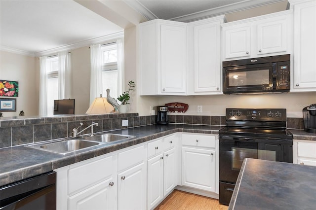 kitchen with white cabinetry, sink, ornamental molding, black appliances, and light wood-type flooring