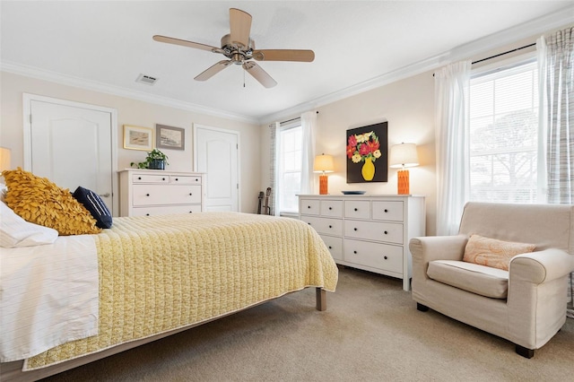 carpeted bedroom featuring ceiling fan and crown molding