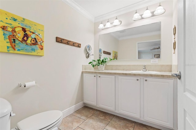 bathroom featuring tile patterned flooring, vanity, ornamental molding, and toilet