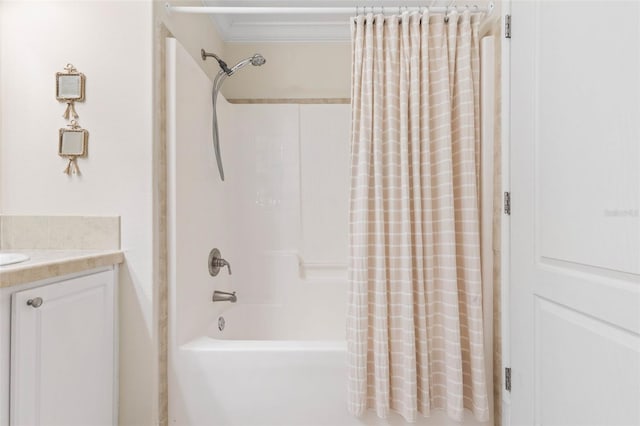 bathroom featuring crown molding, vanity, and shower / bath combo