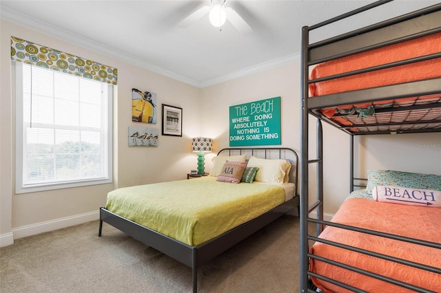 carpeted bedroom with multiple windows, ceiling fan, and ornamental molding