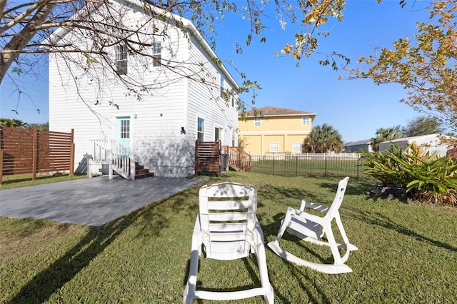 back of property with a yard and a patio