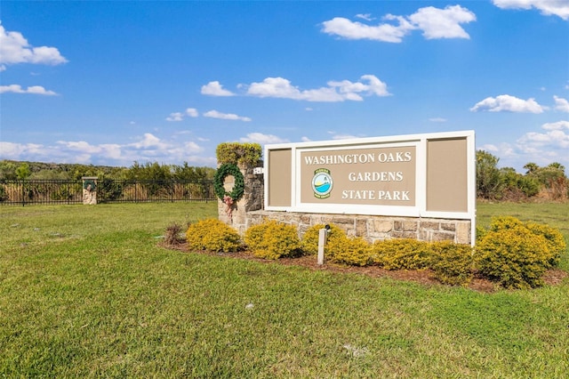 community / neighborhood sign featuring a lawn