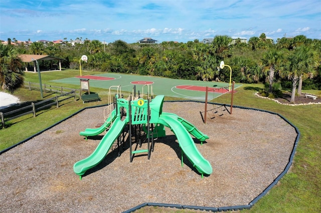 view of playground featuring basketball court and a yard