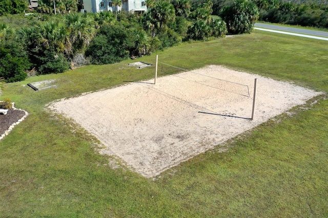 view of community featuring volleyball court and a yard