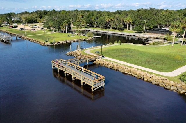 view of dock featuring a water view and a lawn