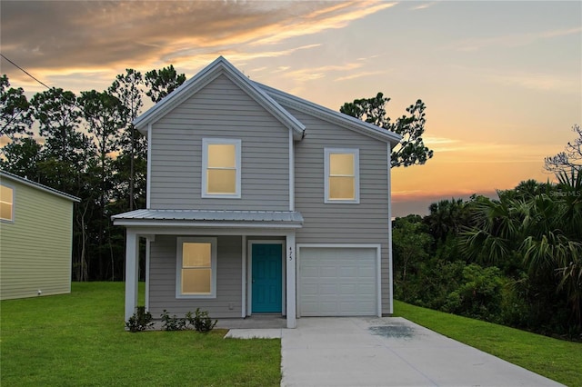 view of front property with a lawn and a garage