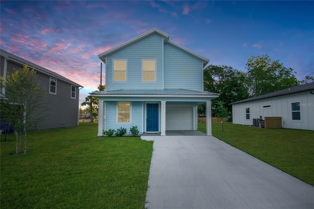 view of front of home featuring a yard and a garage