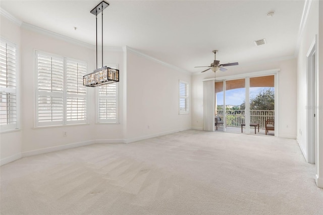 unfurnished living room featuring a wealth of natural light, ceiling fan, light colored carpet, and ornamental molding