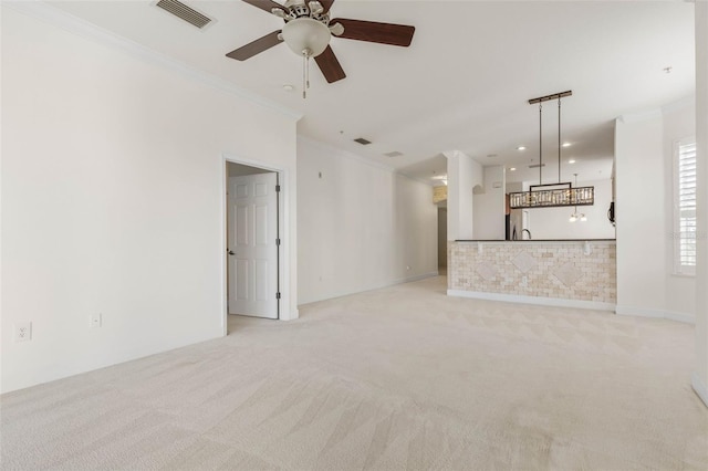 unfurnished living room featuring light carpet, ceiling fan, and crown molding