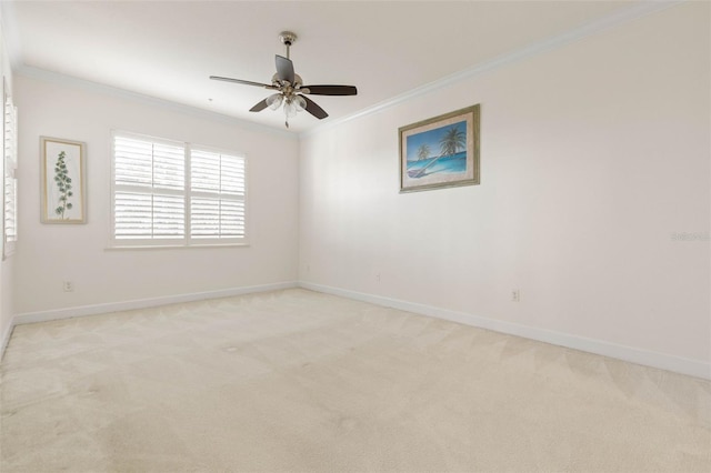 spare room featuring ceiling fan, ornamental molding, and light carpet