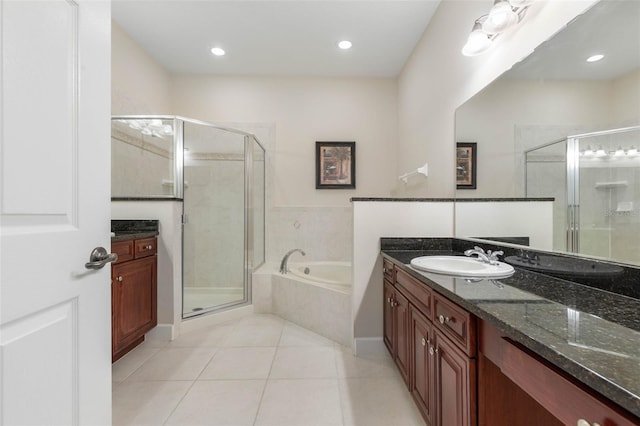 bathroom featuring tile patterned floors, vanity, and independent shower and bath