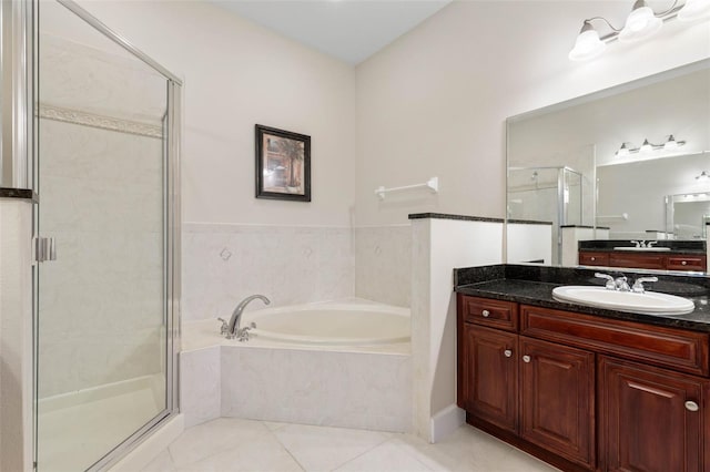 bathroom featuring tile patterned flooring, vanity, and separate shower and tub