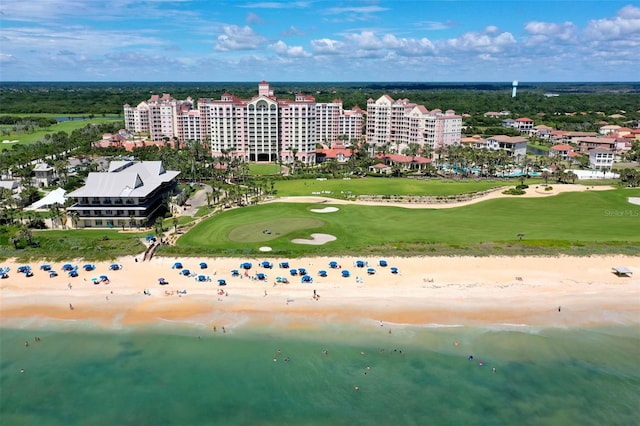 bird's eye view featuring a water view and a beach view