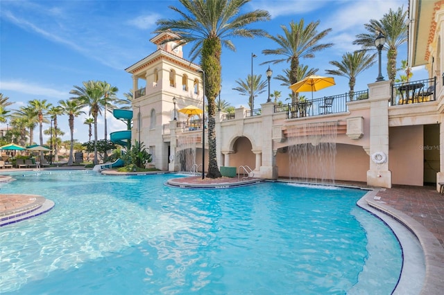 view of pool with pool water feature and a water slide