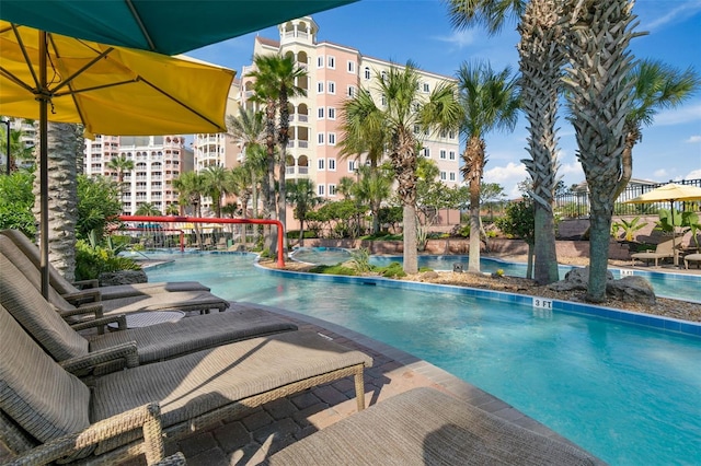 view of pool featuring a patio and a hot tub