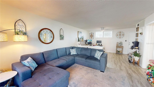 living room featuring a textured ceiling and light hardwood / wood-style floors