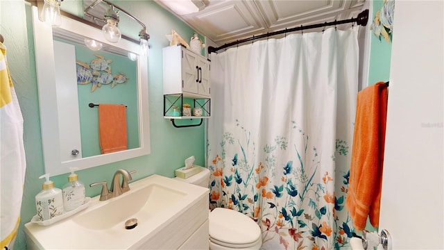 bathroom featuring curtained shower, vanity, and toilet