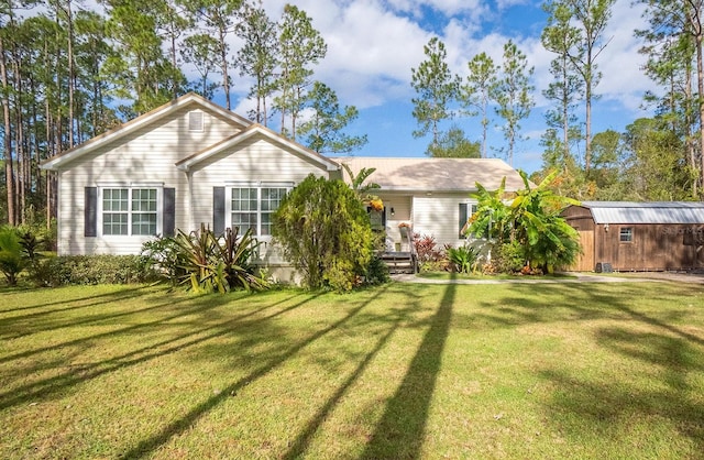 ranch-style house with a front lawn and a storage shed