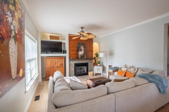 living room featuring crown molding, hardwood / wood-style floors, and ceiling fan