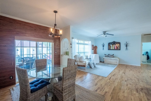 dining area featuring hardwood / wood-style flooring, ceiling fan, crown molding, and a textured ceiling