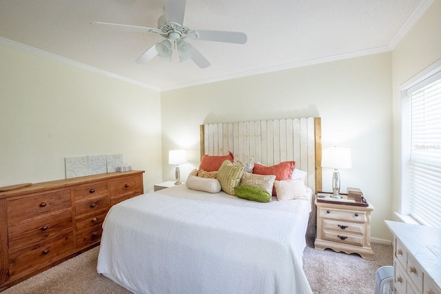 carpeted bedroom featuring ceiling fan and ornamental molding