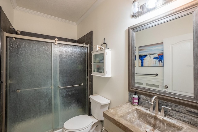 bathroom featuring vanity, a textured ceiling, a shower with door, and crown molding