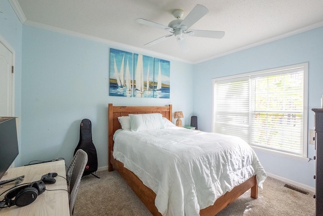 carpeted bedroom with ceiling fan and crown molding