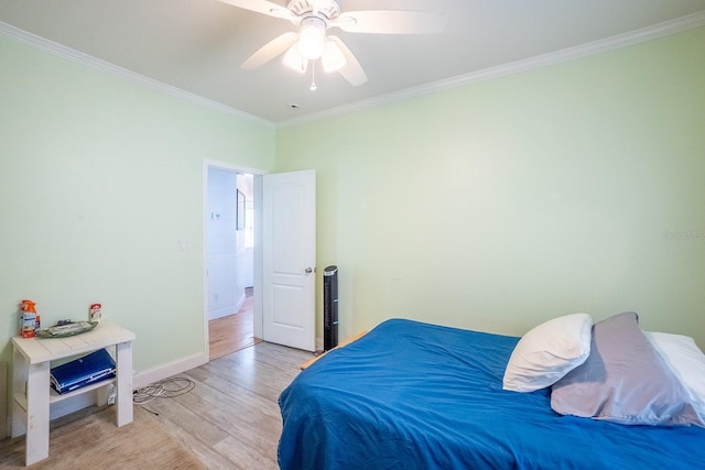 bedroom featuring ceiling fan, ornamental molding, and light hardwood / wood-style flooring