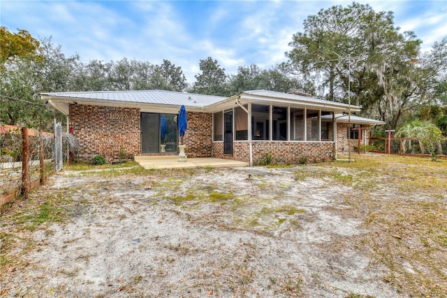 back of property featuring a sunroom