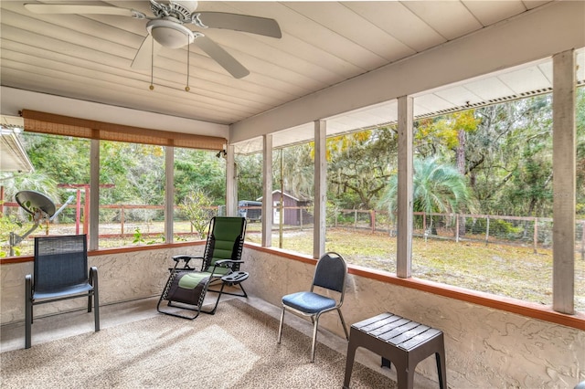 sunroom / solarium with ceiling fan and wooden ceiling