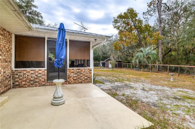 view of yard with a sunroom and a patio