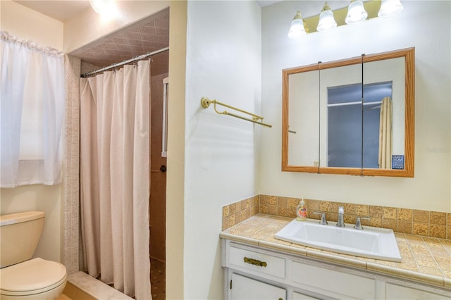 bathroom with vanity, curtained shower, and toilet