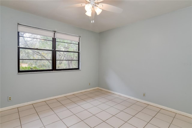 tiled spare room featuring ceiling fan