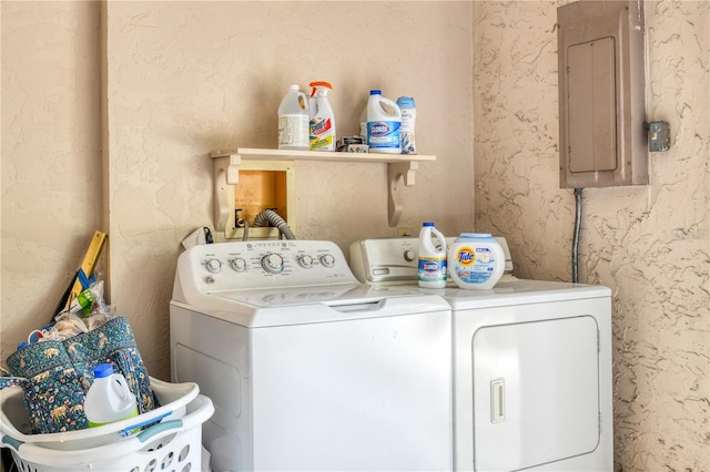 clothes washing area with separate washer and dryer and electric panel