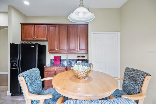 dining space featuring arched walkways, light tile patterned flooring, and recessed lighting