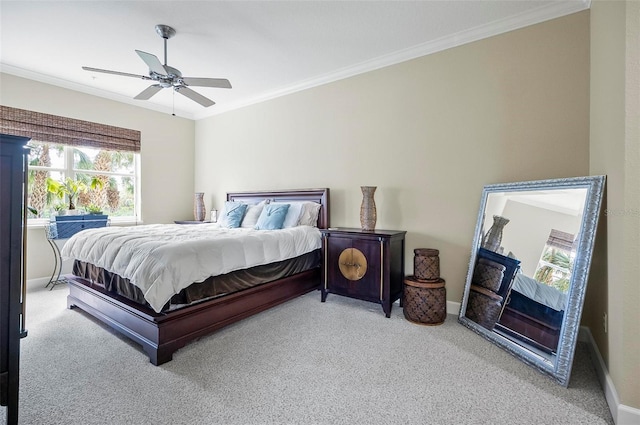 carpeted bedroom featuring baseboards, ornamental molding, and a ceiling fan