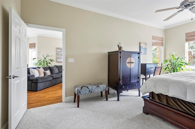 bedroom featuring carpet, ornamental molding, ceiling fan, and baseboards