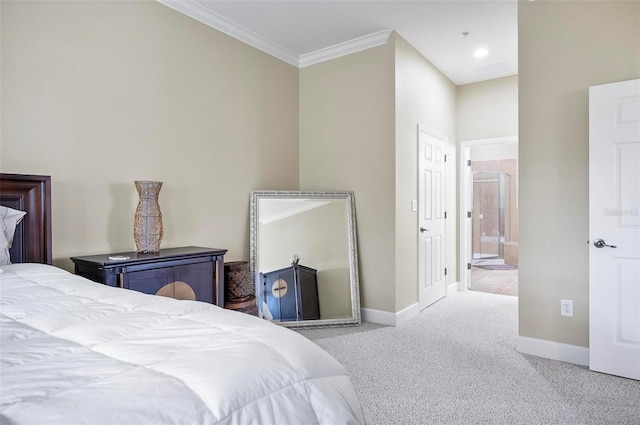 bedroom featuring carpet, crown molding, baseboards, and ensuite bathroom