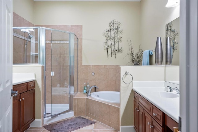 bathroom with tile patterned floors, vanity, and plus walk in shower